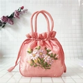Detailed embroidery on pink satin bucket bag with floral patterns and drawstring closure - Orange Red