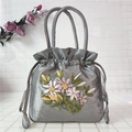Détail de la broderie florale sur le sac à main en satin de soie avec cordon - Gris