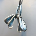 Detailed view of light blue satin paisley scarf tied in a stylish soft bow knot - Sky Blue Paisley