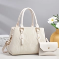 Detail of cream marble-textured tote bag with gold rivets and matching pouch set - Off-white
