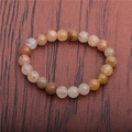 Macro shot of 8mm tiger eye and emperor stone beads on an elastic bracelet band - Yellow Tiger Eye