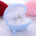 Light blue shell-shaped jewelry box holding a silver ring with a square champagne gemstone - Polygonal Sky Blue Shell