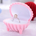 Pink seashell-shaped jewelry box with soft white velvet lining for ring storage - Polygonal Pink Shell