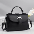 Detail of black lychee texture handbag with silver lock and elegant orchid decoration - Black