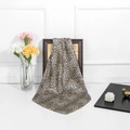 Classic leopard print silk scarf draped elegantly on a frame with a floral vase background - Leopard Print Main Color / 90x90cm