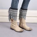 Knit leg warmers with black and white geometric jacquard patterns and tassels on boots - Black/White