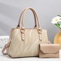 Close-up of beige marble texture handbag with gold hardware and matching wallet - Khaki