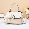 Detail of two-tone handbag with straw texture, horseshoe buckle and cute plush charm - Off-white