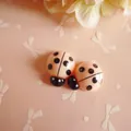 Macro detail of cute resin ladybug DIY accessory for hair clips and phone cases - Orange Pink