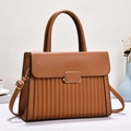 Caramel brown leather handbag with vertical pleats and golden metal buckle details - Earthy Yellow
