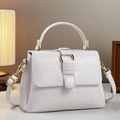 Close-up of white crocodile pattern leather texture with golden metal hardware detail - White
