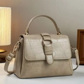 Detail of beige faux crocodile leather handbag with elegant gold metal ring and handle - Khaki