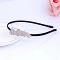 Detailed close-up of a black headband featuring a rhinestone-embellished heart pattern - Rhinestone Heart