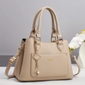 Elegant beige leather handbag for women with dual handles and gold pearl pendant charm - Apricot / 28x13x20cm