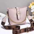Pink bucket bag with lychee leather texture and adjustable brown woven strap - Purple