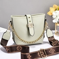 Light green bucket bag with lychee texture and floral patterned wide shoulder strap - Green