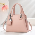 Detail of pink pebbled leather handbag with silver hardware and heart charm decoration - Pink