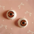Macro view of 20mm brown resin doll eyes with detailed iris texture for DIY crafts - Brown