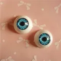 Macro shot of 20mm round doll eyes with blue radial iris for BJD and DIY crafts - Blue