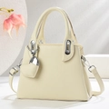 Detail of cream lychee texture leather handbag with silver clasp and heart charm - Off-white