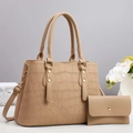 Detail of crocodile pattern handbag and wallet set with gold studs and shoulder strap - Apricot