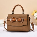 Brown woven square bag with leather bow decoration and detachable shoulder strap - Earthy Yellow