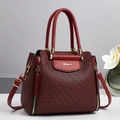 Elegant deep red textured leather handbag with dual handles and gold Dakarce logo - Burgundy