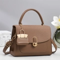 Elegant tan faux leather crossbody bag with woven flap and mini charm accessory - Brown