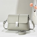 Close-up of light green lychee pattern leather texture with silver metal square buckle - Gray