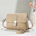 Close-up of beige litchi grain leather shoulder bag with silver buckle and dry flower decor - Light Khaki