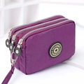 Three-zipper washed denim purple clutch purse with portable wristlet strap and logo - Medium / Deep purple