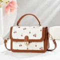 Elegant cream crossbody bag with cherry floral print and brown leather handles - Coffee