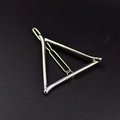 Dettaglio del fermaglio per capelli a triangolo in metallo argento su sfondo scuro - Argento