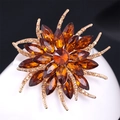 Elegant amber crystal flower brooch with gold tassels and cubic zirconia accents - Champagne