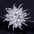 Elegant silver flower brooch with sparkling crystal rhinestones in a radial floral design - White
