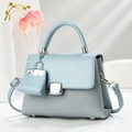 Chic light blue macaron handbag with textured weave pattern and mini charm accessory - Sky Blue