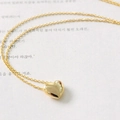 Elegant gold heart pendant necklace with fine chain on minimalist paper background - Gold 2005