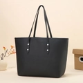 Minimalist black pebbled leather tote bag with silver rivets and slim shoulder straps - Black