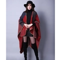 Detail of color-block knit poncho showing burgundy and grey panels with whipstitch edges - Red