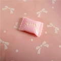 Macro view of a pink resin candy-shaped accessory with engraved Sweet text for DIY crafts - Sweet Lettering / Light Pink
