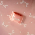 Detail shot of light pink resin candy charm with Sweet text for DIY hair and shoe accessories - Sweet Lettering / Pink