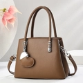 Brown grainy leather tote bag with heart charm and detachable shoulder strap on display - Dark Khaki