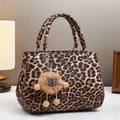 Elegant leopard print tote bag with plush charm on a minimalist white table setting - Dark Khaki