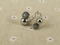 Macro view of gunmetal spiral ring featuring polished spheres and pavé grey crystals - Black Silver 4-Ball Open Style