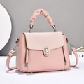 Detail of pink pebbled leather handbag featuring ruched handle and metal twist-lock - Pink