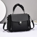 Black pebbled leather handbag with woven flap and silver twist-lock closure for women - Black