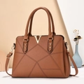 Detail of caramel leather tote with textured finish and V-shaped gold metal hardware - Khaki/Earth Yellow