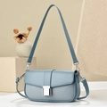 Light blue crossbody bag with textured patchwork design and silver metal clasp buckle - Soft Blue