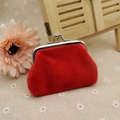 Bright red plush coin purse with silver kiss-lock clasp on a decorative floral background - Red