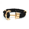 Detail of nautical anchor clasp in gold with black braided cord rope bracelet - Gold Anchor - Black Rope